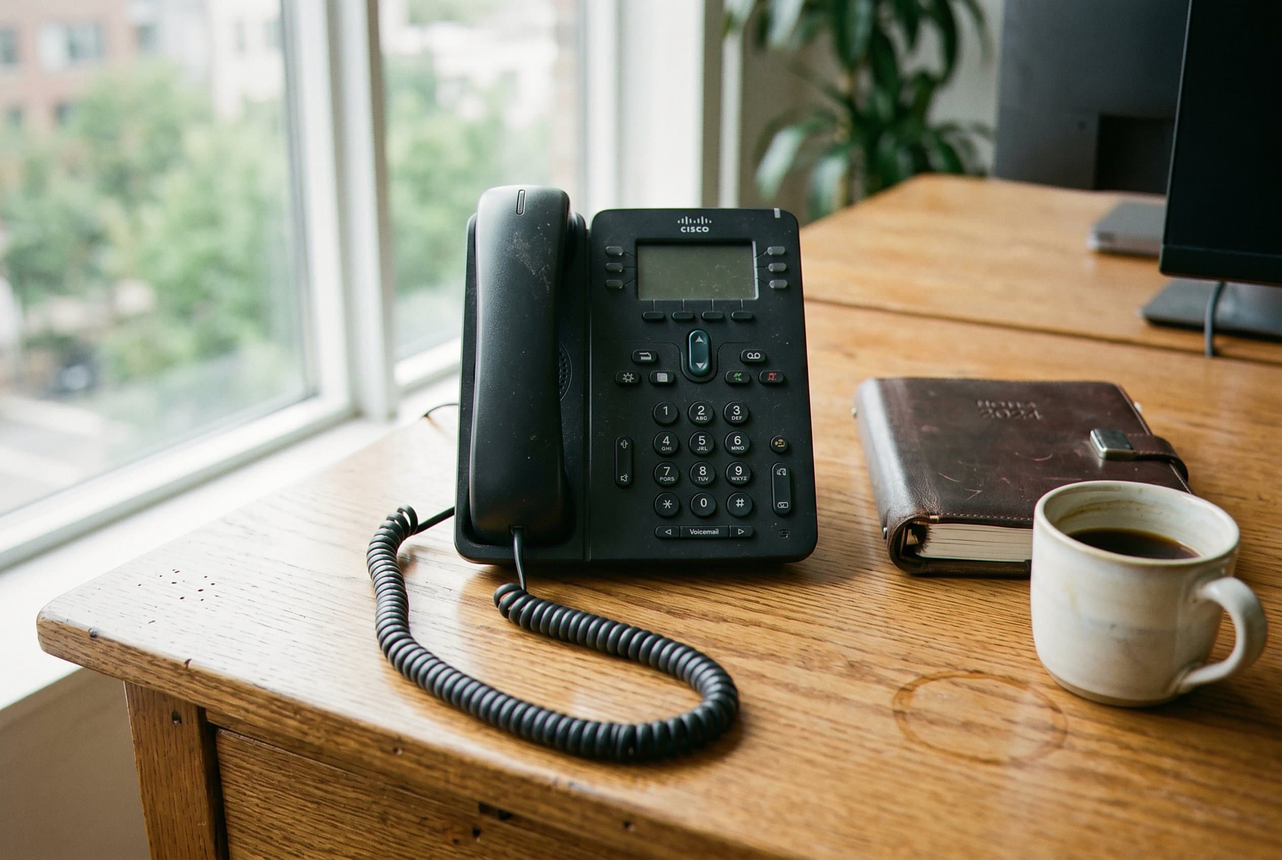 Receptionist answering phone at desk, late night.