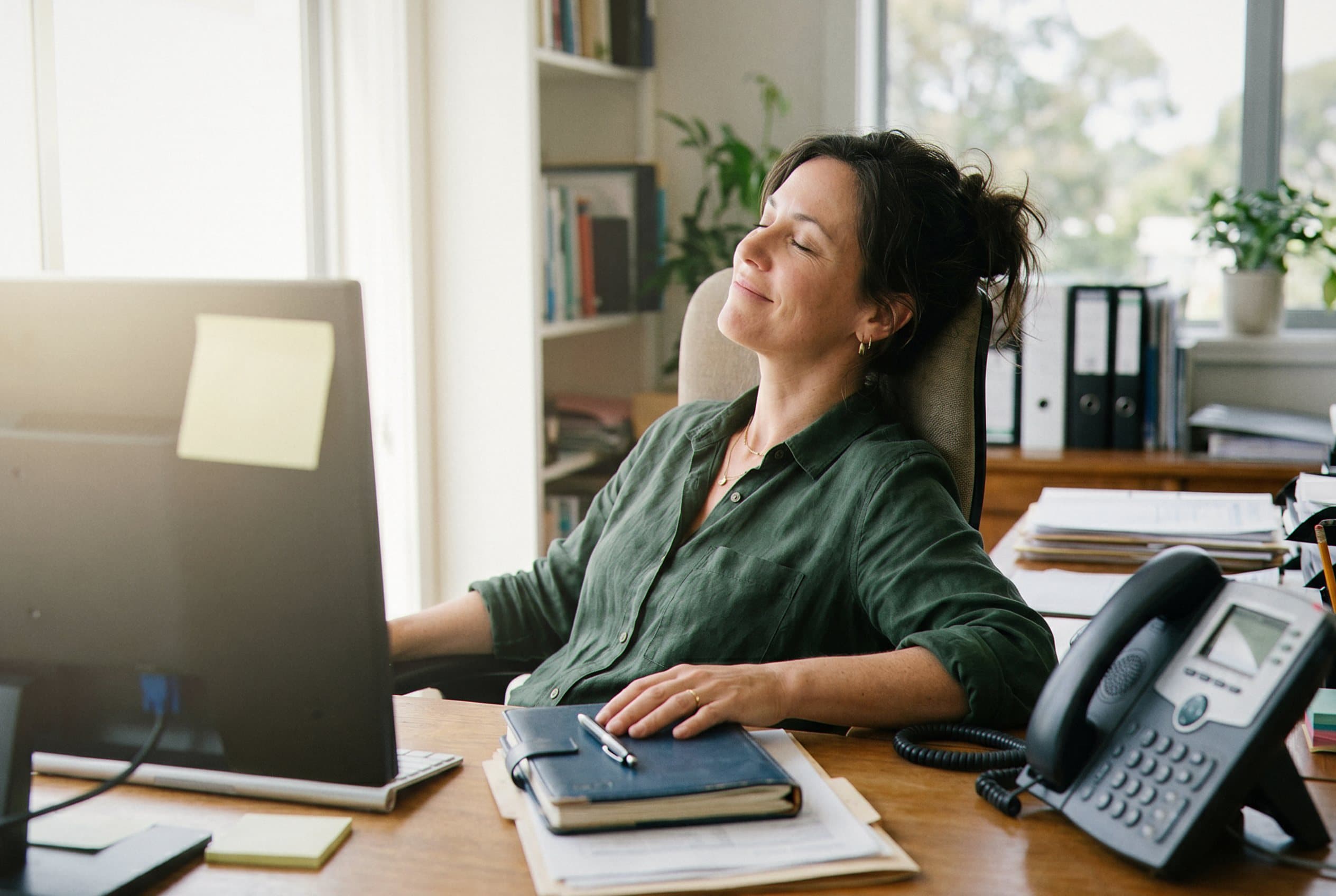 Business owner looking relieved at desk.
